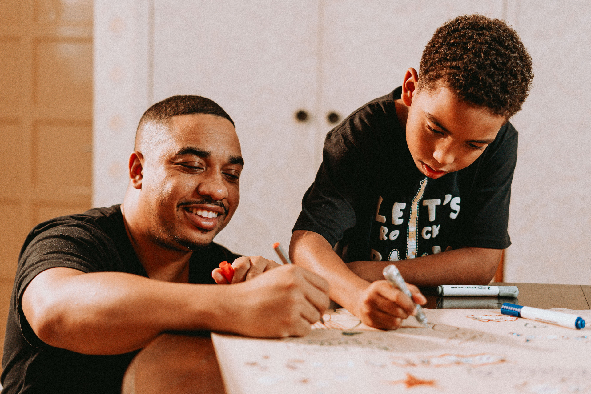 Adult and child drawing together